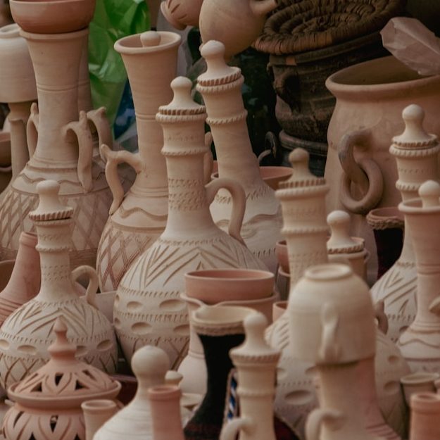 A lot of vases that are on a shelf